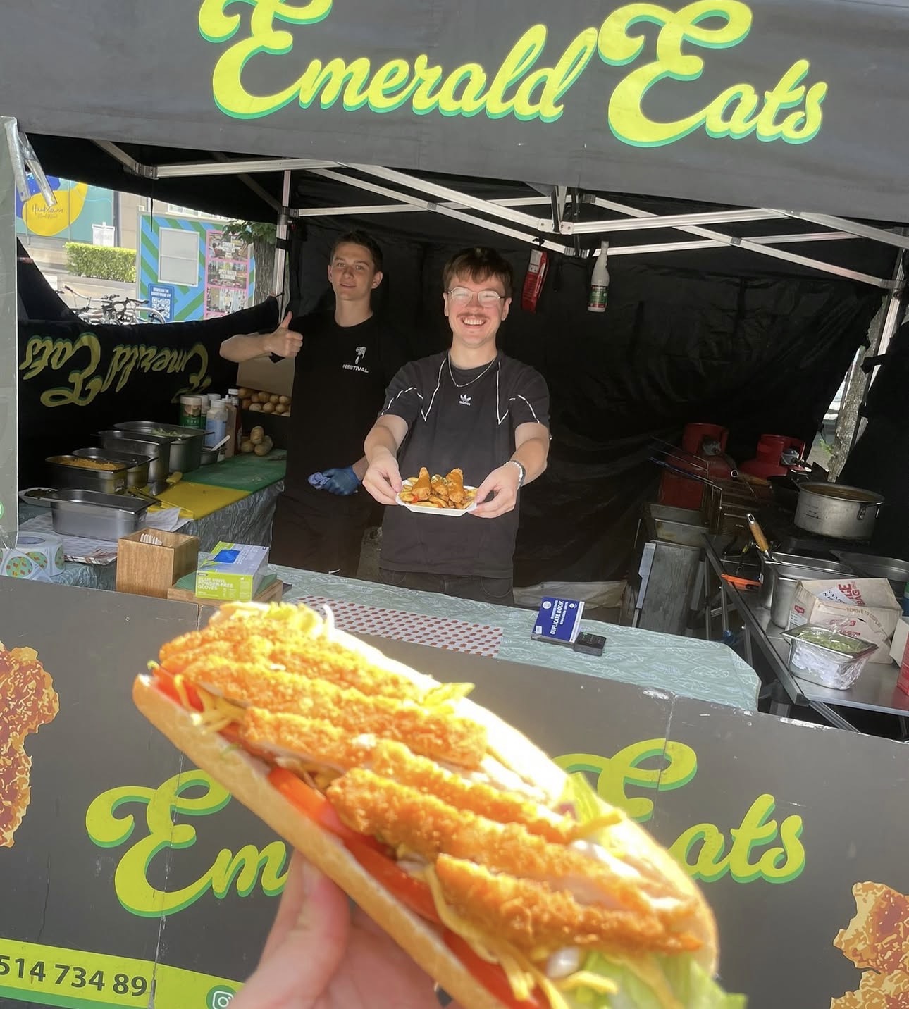 Emerald Eats gazebo stall serving a fresh chicken baguette